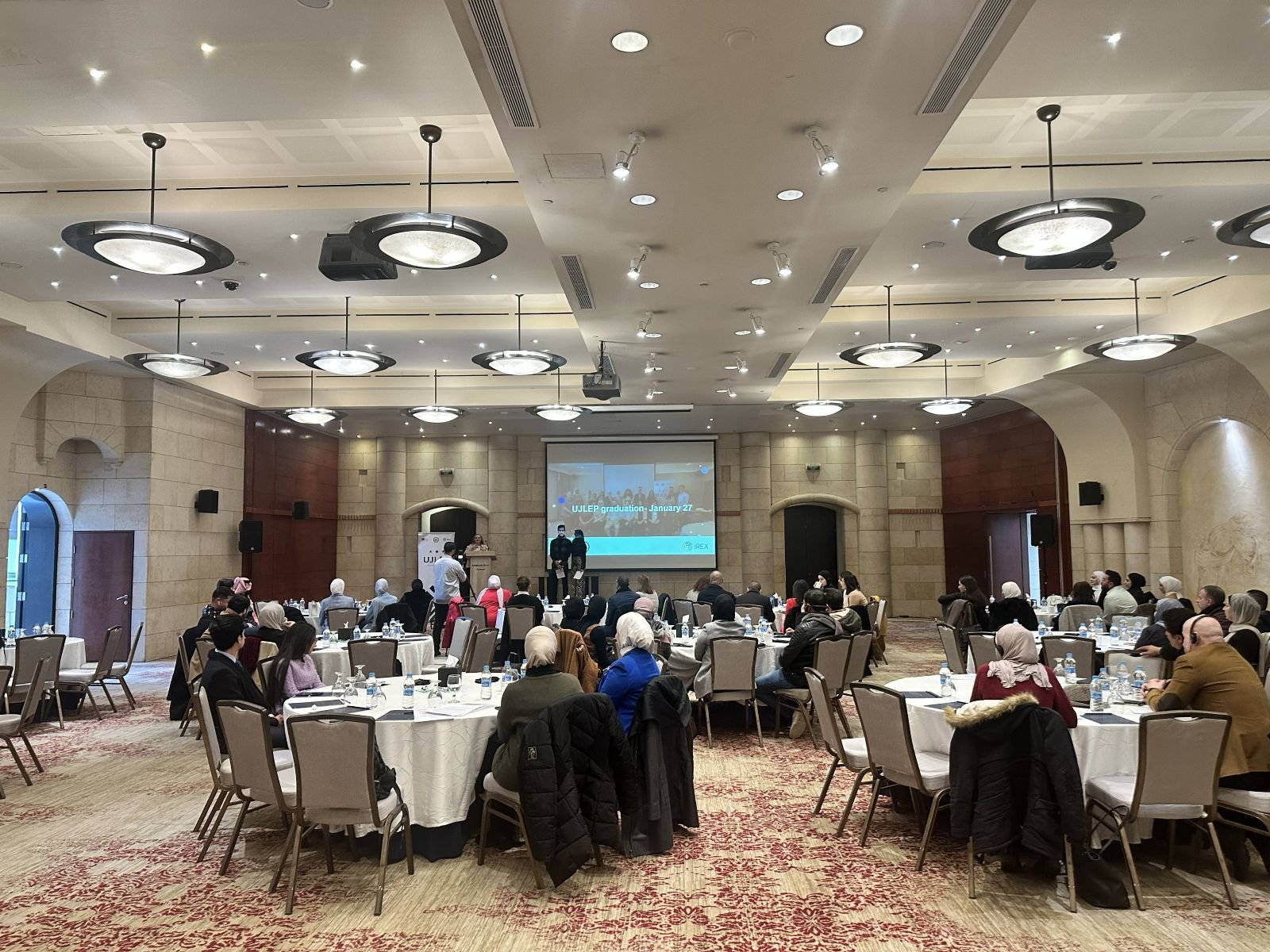 Workshop audience in a ballroom with projection